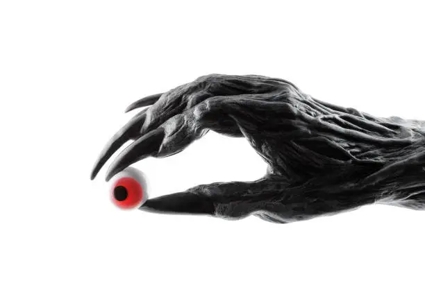 Creepy monster hand with red eyeball isolated on white background with clipping path