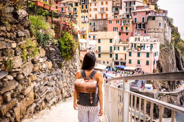 Latin woman visiting beautiful town in Cinque Terre coast, Italy stock photo