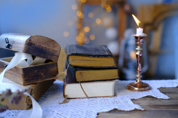 istock old family photos in vintage interior, stack nostalgic sentimental pictures, candle burning, relic box, stack of books, concept genealogy, memory ancestors, family tree 1472370102
