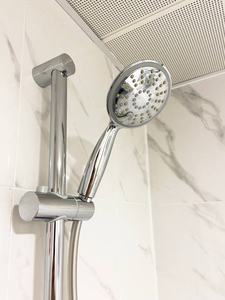 istock Shower head hanging on the ceramics tile wall 1472370133