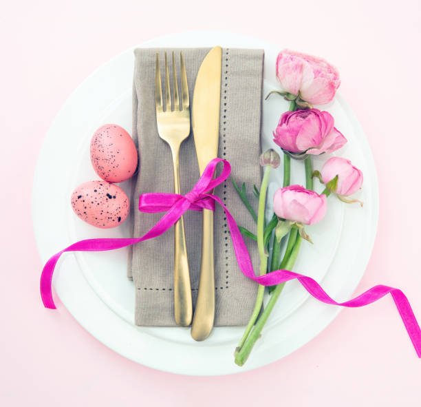istock Easter table setting, Easter eggs and flowers decoration, napkin and golden cutlery 1472373224