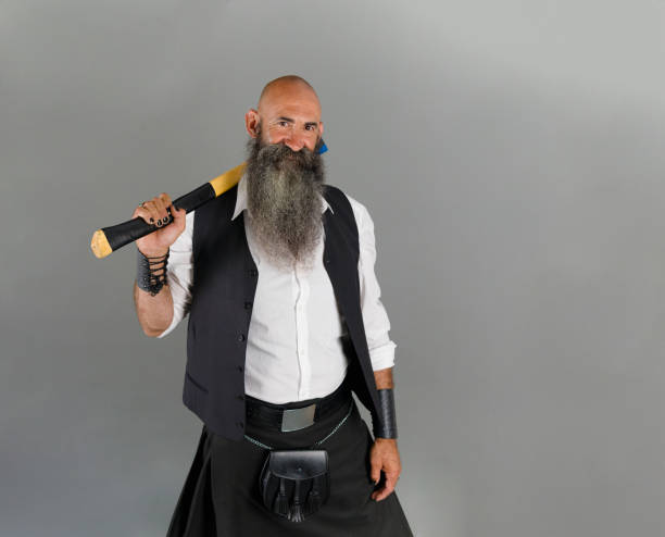 istock a head shaved mature man with long beard looking at camera while holding an axe behind one shoulder 1472373271