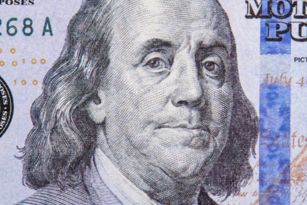 istock Benjamin Franklin portrait macro usa dollar banknote or bill. Benjamin Franklin's look on a one hundred dollar bill 1472374453