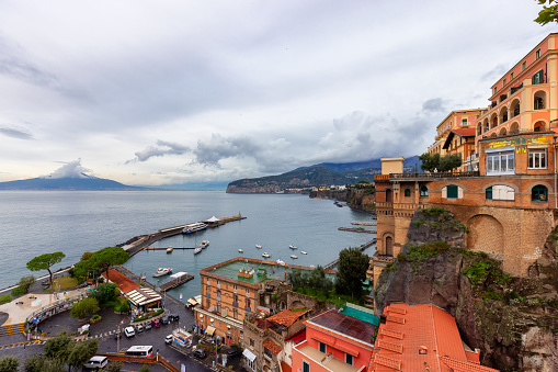 Panoramic view of Genoa in Liguria, Italy with pastel coloured houses and port in background