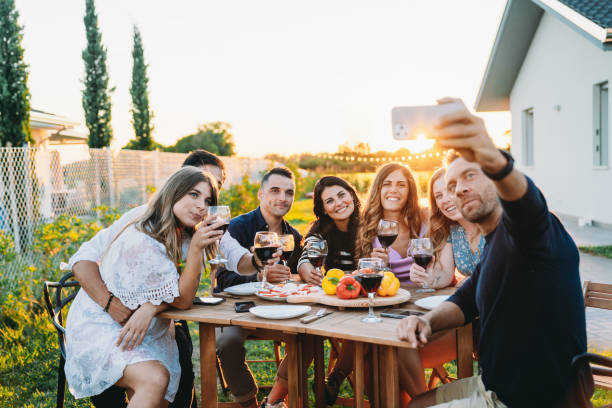 istock Friends are taking a selfie together during a dinner party 1472375196