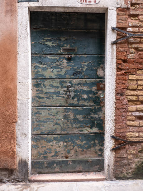istock Weathered Wooden Front Door on Old Building in Venice 1472375499