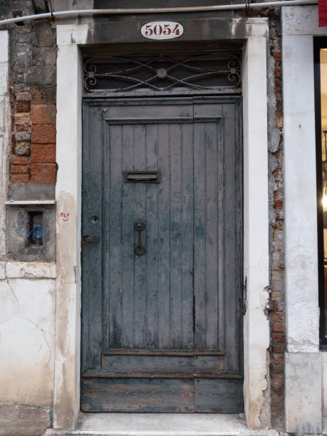 istock Weathered Wooden Front Door on Old Building in Venice 1472375507