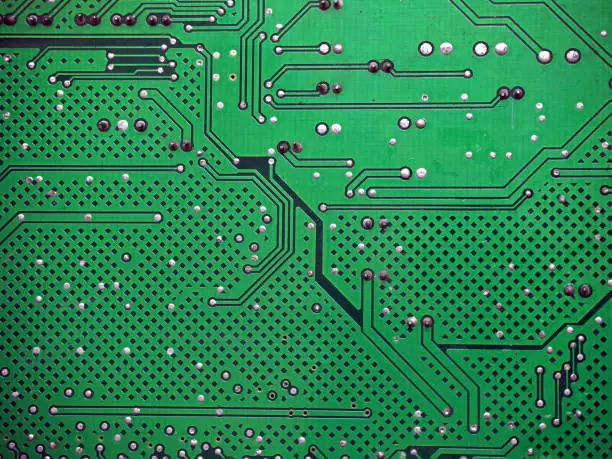 Electronic circuit board background. Digital high-tech texture. Soldered surface of a PCB.