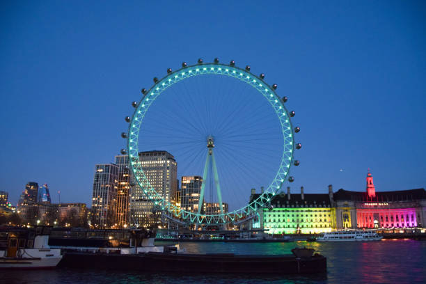 London Eye lights up in green for St Patrick's Day, London, UK London, UK  - March 17th 2021: London Eye illuminated in green for St Patrick's Day houses of parliament london photos stock pictures, royalty-free photos & images