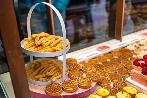 Showcase with various products for breakfast and typical churros from Madrid, Mercado de San Miguel