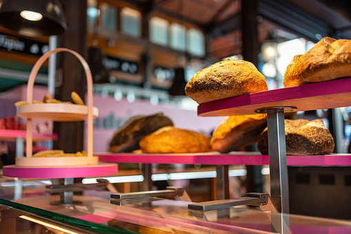 Bakery showcase with shelves and breads of various types exposed for sale to the public, Mercado de San Miguel, Madrid