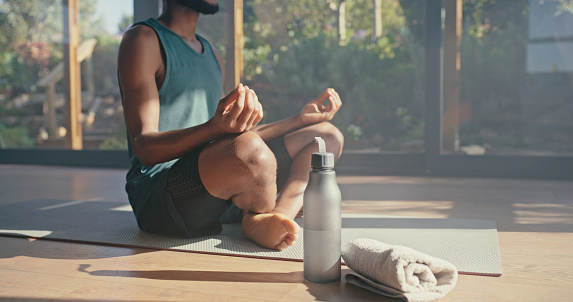 Meditation hands, black man and lotus on mat in home of mental health, zen and pilates. Closeup, yoga and guy meditate on floor for wellness, exercise energy and fitness workout for chakra mindset