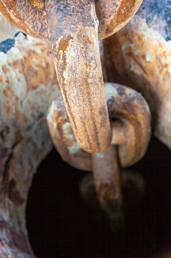 Ship's anchor chain in the anchor hawse on the ship, close-up.