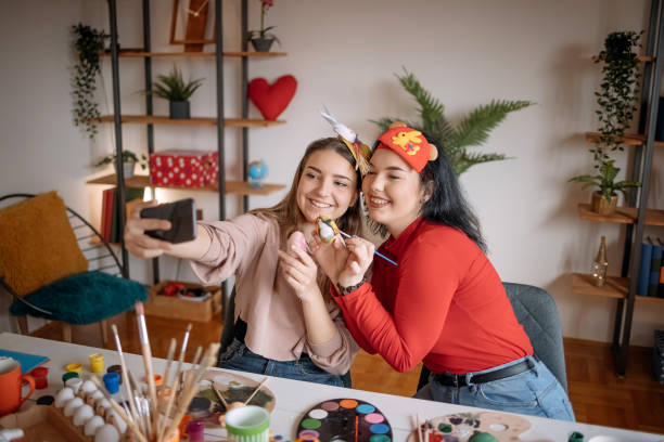 istock Two young women friends having fun at home with preparing Easter decoration 1472382464