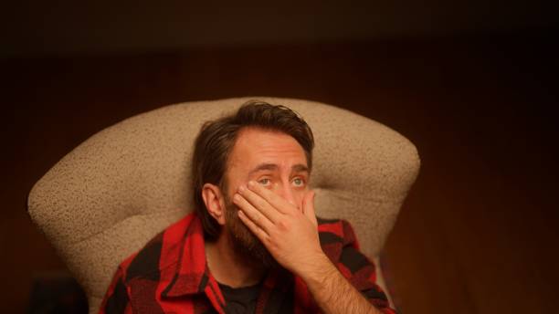 istock Studio portrait of handsome man sitting on sofa 1472383567