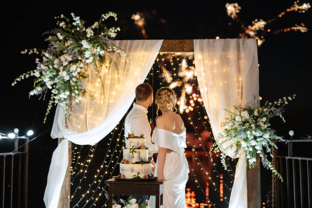 istock newlyweds happily cut and taste the wedding cake 1472383626