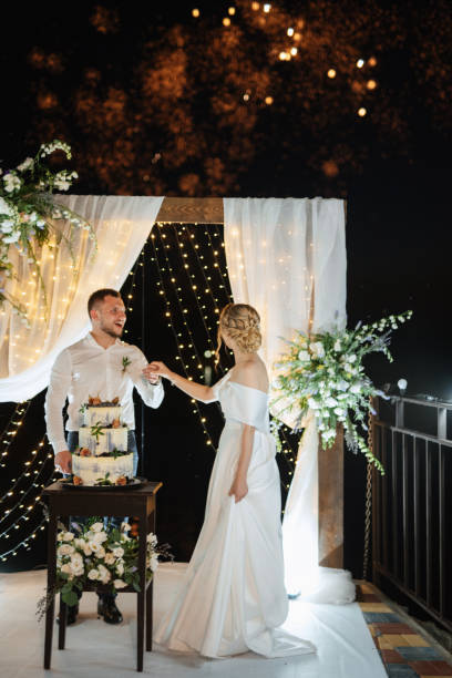 istock newlyweds happily cut and taste the wedding cake 1472383740