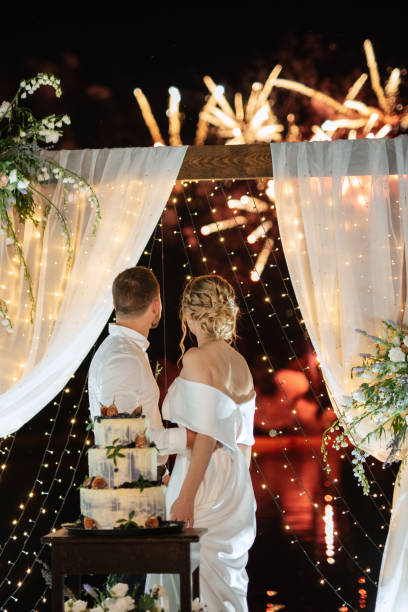 istock newlyweds happily cut and taste the wedding cake 1472384748