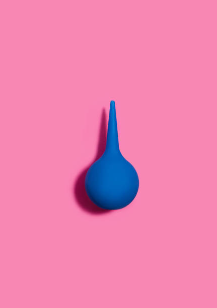 istock Blue pear-shaped enema on a pink background. Cleansing the body. Flat lay. 1472388972