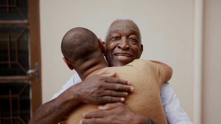 Father and son embracing at home