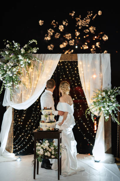istock newlyweds happily cut and taste the wedding cake 1472390576