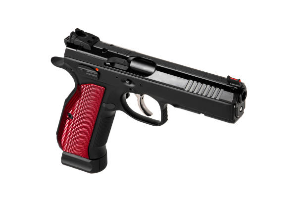 istock A modern black semi-automatic pistol with a red grip. A short-barreled weapon for self-defense and sport.  Isolate on a white background. 1472392898