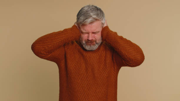 istock Annoyed irritated senior man covering ears, gesturing No avoiding advice ignoring noise loud voices 1472396858