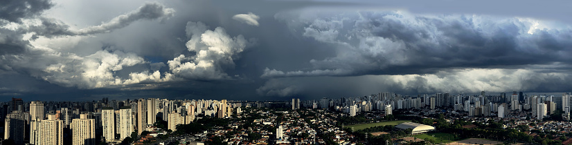 Grey black clouds of a storm come in the background. Sao Paulo, Brazil. Panoramic photo.