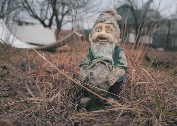 Garden decor. Retro style. Home street decor. The figure of a gnome. Peeled paint.