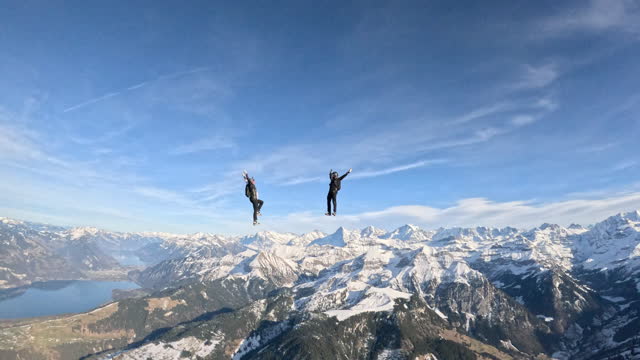 Freefall jumpers soar above Swiss mountain landscape