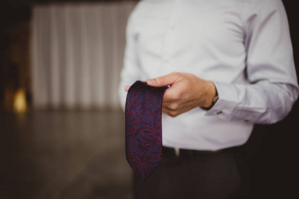 istock Man tying a neck tie 1472399169