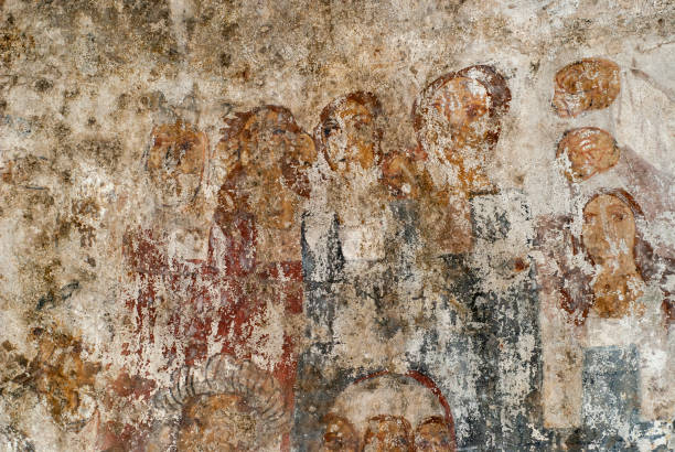 istock Faces of old decaying medieval frescoes. 1472399251