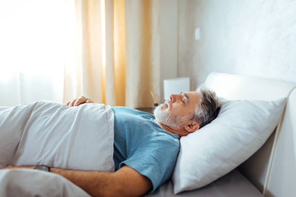 istock Sweet Dreams. Mature Caucasian Man Sleeping Peacefully in Bed 1472399407