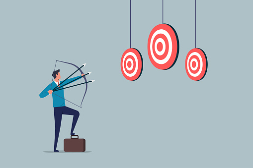 Aiming for many targets or goals in one shot, multitasking or multi purpose strategy, skillful businessman aiming multiple bows on three targets, achieve more in one time