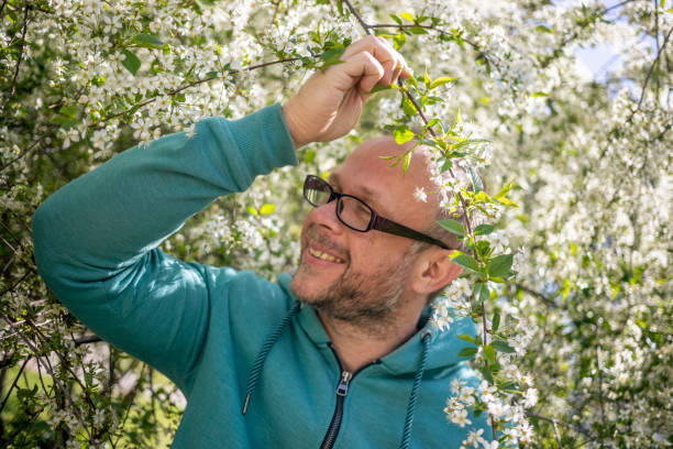 Portrait of Adult man with blooming cherry tree