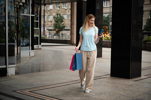 Portrait of a beautiful young woman enjoying shopping in the city