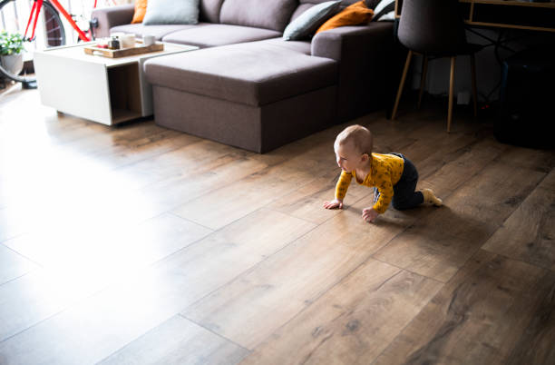 istock Baby boy crawling on the floor and smiling. 1472405398