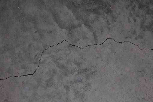 Crack in grey concrete surface