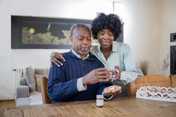 istock Retired man with female home carer 1472407799