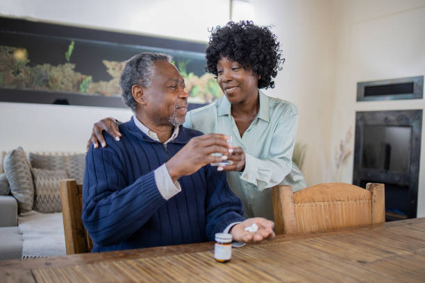 istock Retired man with female home carer 1472407802