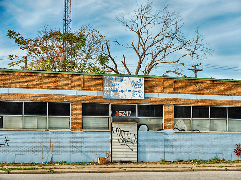 Detroit, Michigan - October 20, 2020: A building used for a nursery school is boarded up and abandoned on Hamilton Avenue in Highland Park.