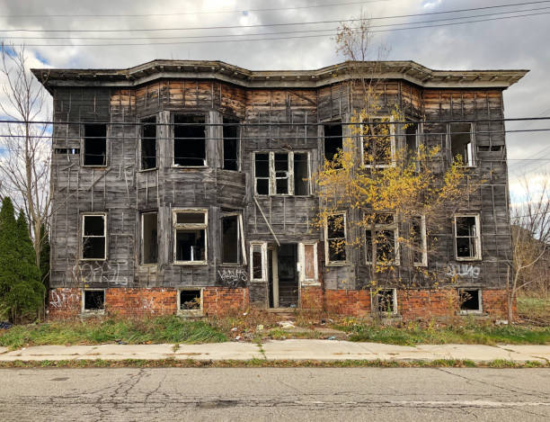 Gutted Apartment Building In Detroit Detroit, Michigan - November 23, 2020: An apartment building on a street in Detroit is burned out and gutted. highland park michigan stock pictures, royalty-free photos & images