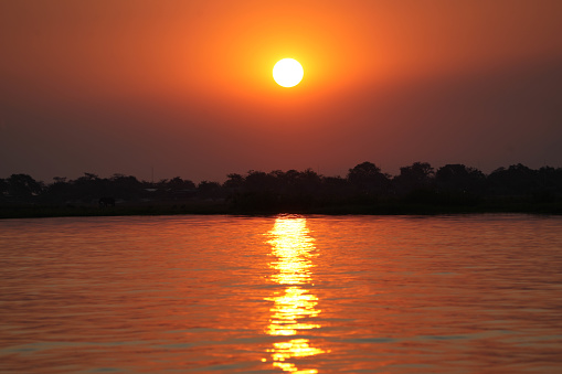 Sunrise scene  colorful traditional fishing boat at U Bein Bridge in the Amarapura Township of Mandalay at sunset,