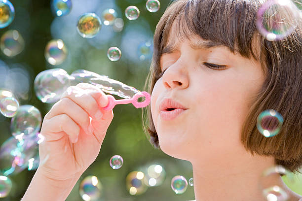 istock young girl blowing bubbles 147242093
