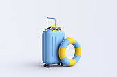 Suitcase, glasses and inflatable circle on white background.