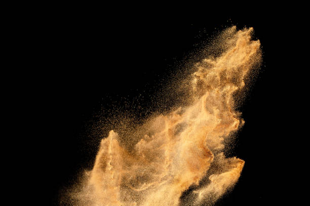 istock Dry river sand explosion.Brown color sand splash against black background. 1472422736
