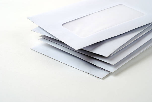 Stack of blank mail envelopes on a white background stock photo