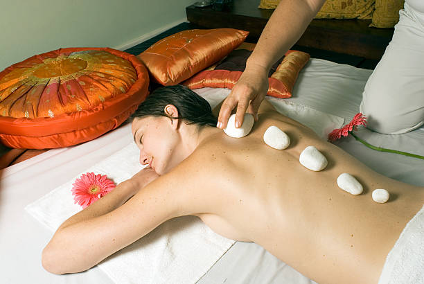 istock Girl Getting Rocks Placed on Spine - horizontal 147242412