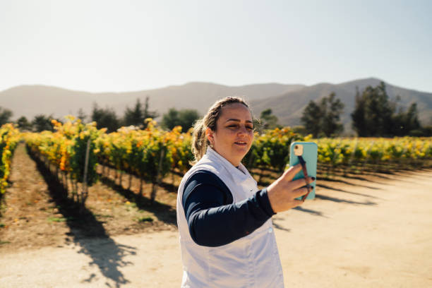 istock Woman taking selfie in the vineyard 1472425252