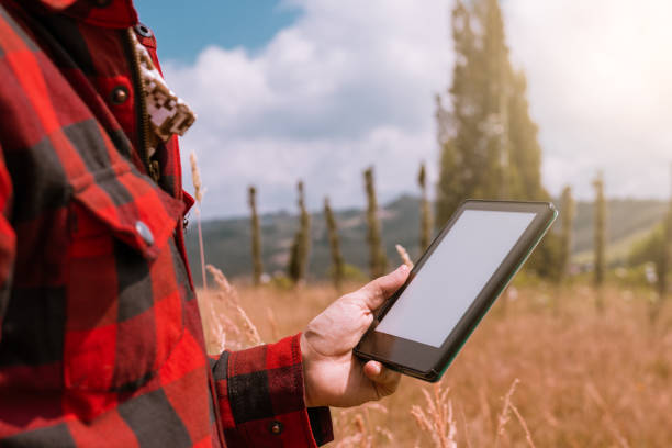 istock Digital Farming: Farmer Checking Crops on Tablet in Sunny Field 1472432615